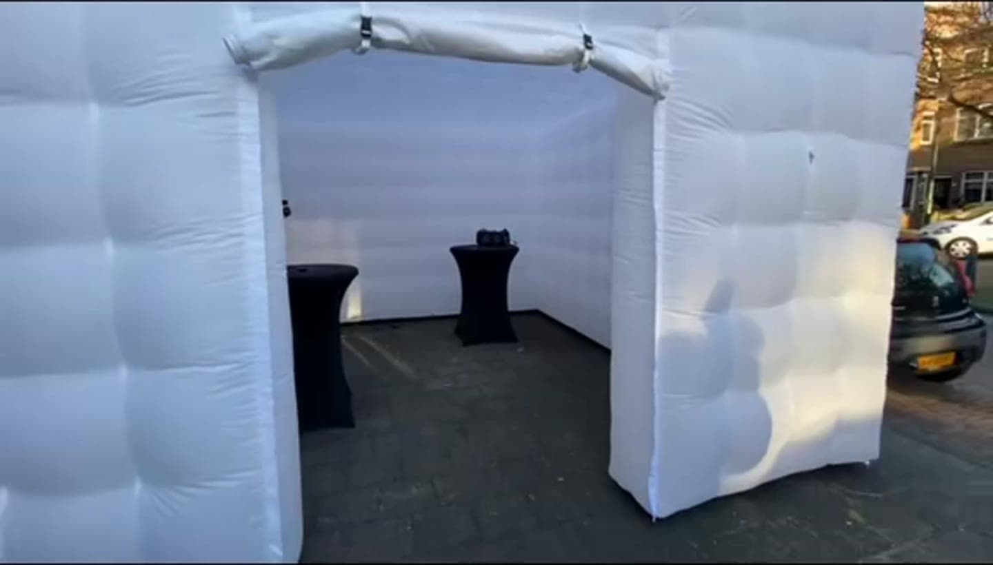 Inflatable disco opgebouwd op straat met statafels binnenin